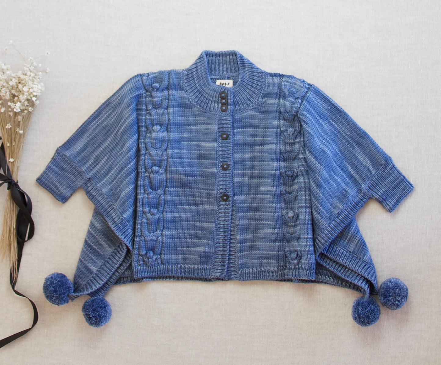 cable bobble poncho. indigo